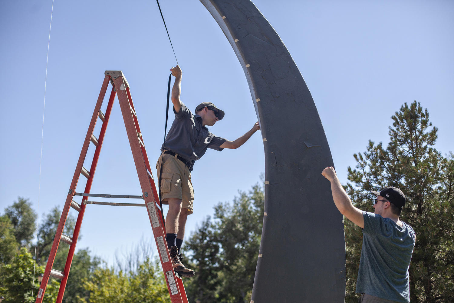 Alumni Max Fagin '06 and Tyler Boschert '07 work on the sundial they created dur